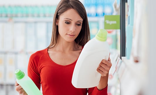 Shopper compares detergents in aisle