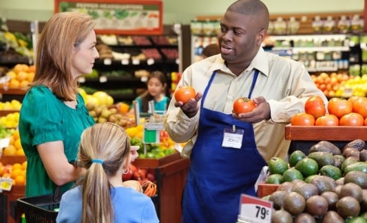 Grocery employee helping customers